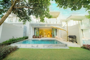 A view of Villa's exterior from the backyard, with a vista of BRG golf course. 