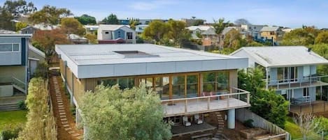 Sliding doors lead from the light-filled living, dining and kitchen onto an expansive deck