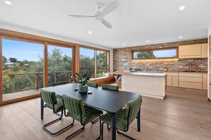 The kitchen and dining area take in the surrounding landscape