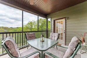 Screened porch overlooks the 13th hole of prestigious Ledgestone Golf Course.