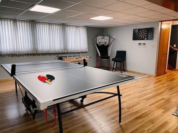 Ping pong table with an abundance of paddles and balls. Shoot some hoops or try for a bullseye on the electronic dart board. 