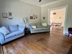 Living room with lots of seating and large smart tv.