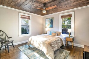 Main floor bedroom: Queen bed with dresser and closet storage for clothing.