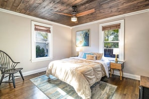 Main floor bedroom: Queen bed with dresser and closet storage for clothing.