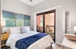 Queen bedroom with sliding glass door to shared back yard