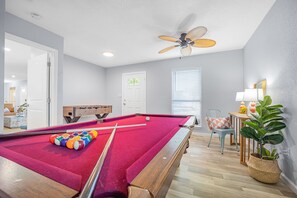 Game room with pool table and foosball and work station . Board games available 