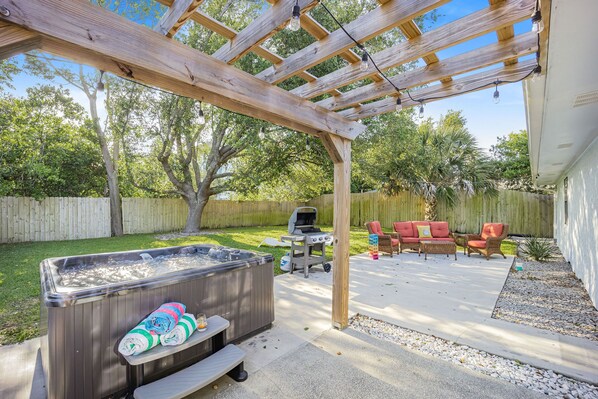 Enjoy the backyard with the hot tub and grill .Lots of room for corhole game 