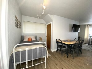 Twin bed next to the closet under the stairs.