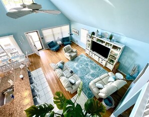 Wider aerial view of open living room from upstairs.