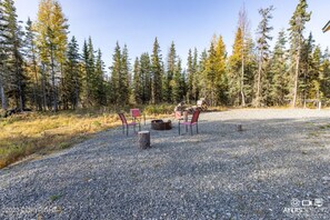 Outdoor firepit area with chairs- this is a shared space.