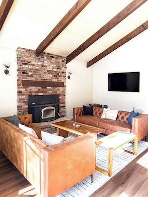 Cozy up by the fire place and enjoy a movie on the 55 inch TV with Netflix.