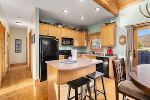 Fully-stocked kitchen and island to prepare and cook meals.