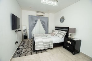 Luxury bedroom leading to the balcony overlooking the highway heart of Accra
