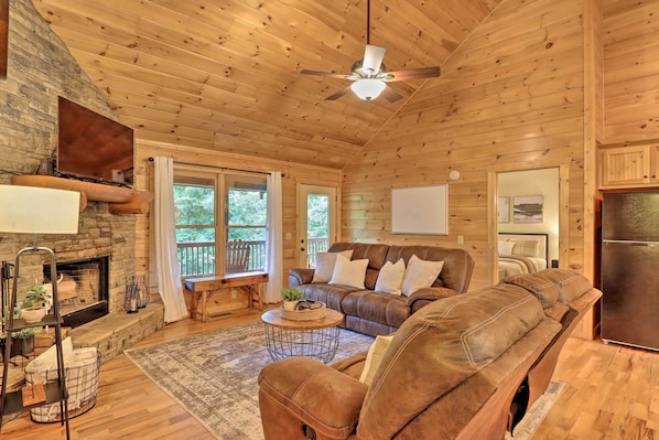 Cozy up in this family room with reclining sofas, a SMART TV, and a fireplace.