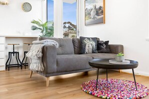Sink into the inviting sofa and enjoy the playful decor, natural light, and stylish touches that make this space feel warm and welcoming