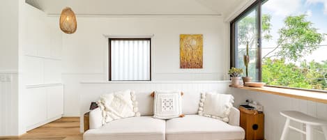 Living room with sliding windows opening up fully to the outside