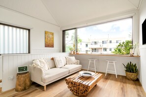 Living room with dining bench opening to the outside.