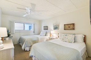 Guest bedroom with two queen beds and a Smart TV