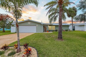 A charming coastal home with a lush lawn and tropical vibes—your perfect Florida escape starts here.