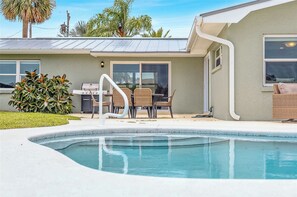 Lounge by the private pool with plenty of seating and a propane grill ready for your next cookout.