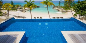 Elevated infinity pool overlooking the secluded beach cove. 