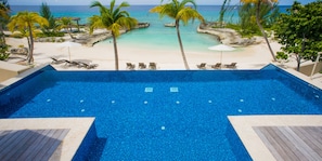 Elevated infinity pool overlooking the secluded beach cove.