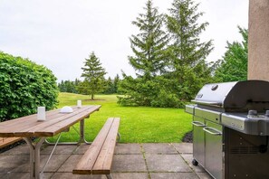 Spacious patio with dinning table and BBQ backing onto the Golf Course. 