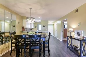 View from the living room into the dining/kitchen and entry. 