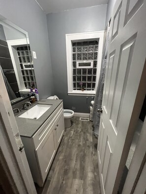 Bathroom 1  with jacuzzi tub and square shower head located on the 1st floor. 