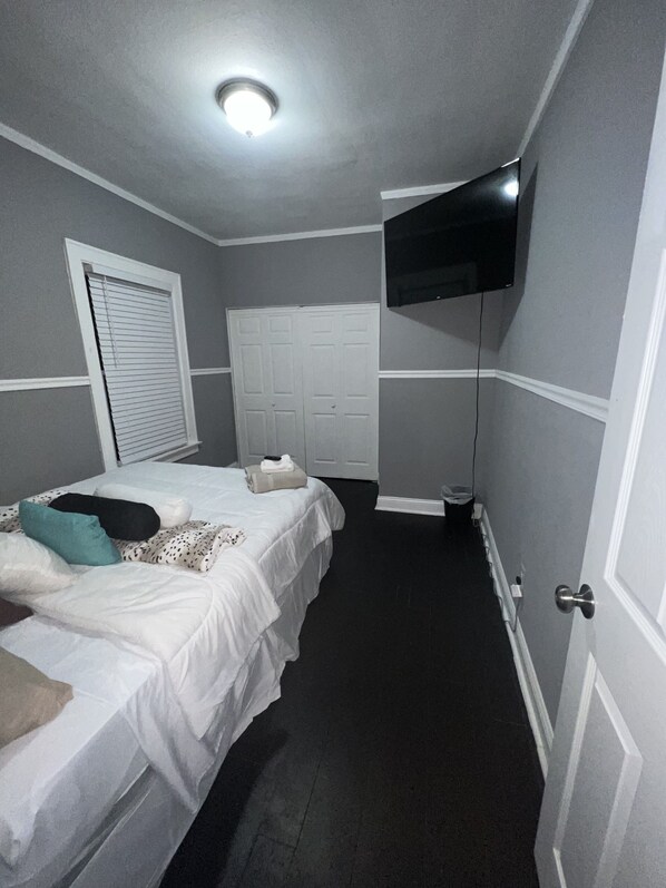 2nd Bedroom on the 1st floor with a  queen bed, flat-screen TV, walk in  closet
