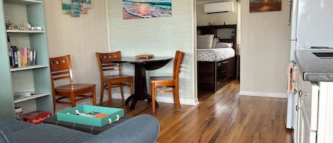 Newly updated fully furnished condo-kitchen, living, dining, and sleeping area.