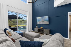 L-shaped sofa with a large smart TV and premium cable.