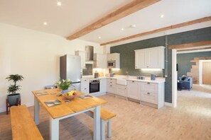 Large kitchen and dining area with dishwasher and espresso machine