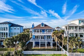 Stunning coastal home with panoramic views and vibrant palm-lined surroundings!
