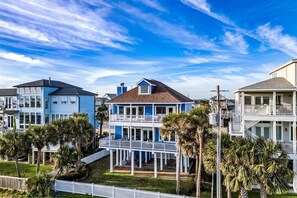Experience stunning coastal living with palm trees and vibrant beach houses!
