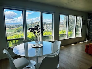 Huge windows line the dining room and living room.