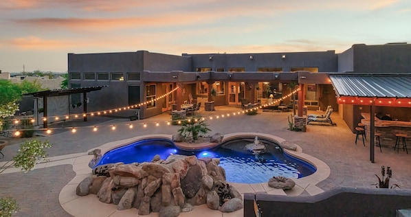 Imagine enjoying the outdoor heated shower, dining area, or plush seating.