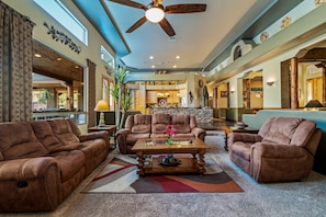 Spacious great room has 14' ceilings and French doors that access the backyard.
