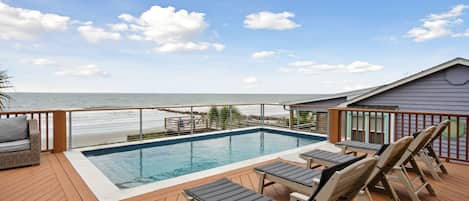 Private deck with saltwater heated pool; enjoy views and sounds of waves crashing on the beach.