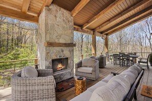 Outdoor Stone Wood Burning Fireplace with Plenty of Deck Seating