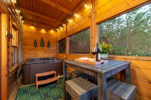 Enjoy a private hot tub in a screened-in porch