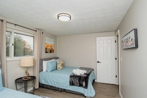 Ideal for families or friends, this bedroom features two full-size beds with plush linens.