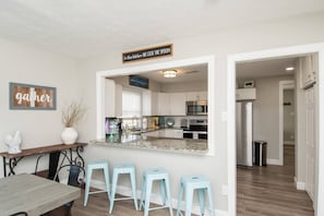 Large island in kitchen opens up to the spacious dining room