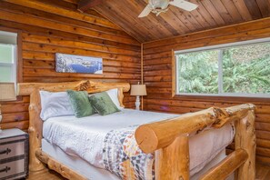 Bedroom 1 features a beautiful queen size hand-crafted log bed