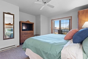 Master bedroom features a king size bed and jetted tub for ultimate relaxation