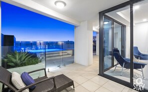 Spacious balcony is right next to the living area and the pool