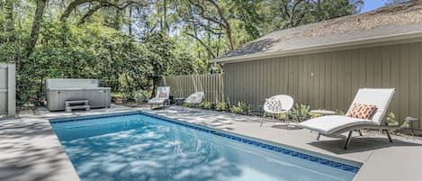 Backyard patio, pool, and hot tub with plenty of loungers.  Yard is fully fenced.