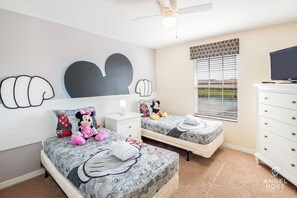 Bedroom 4 is a Mickey-themed room with two 2 beds and a TV. Great for kids!