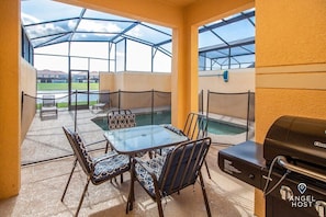 Back dining area with BBQ grill and removable mesh safety fence.