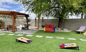 Step into your personal outdoor oasis! Our expansive backyard is a playground of fun and relaxation. Engage in friendly competition with games like corn hole and giant four in a row, unwind in the hammocks, fire up the BBQ grill for a delightful cookout,